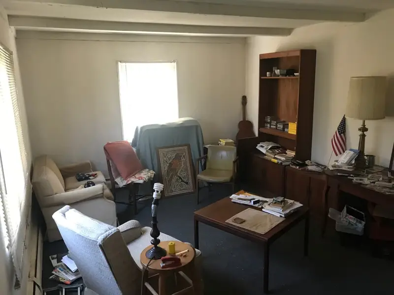 Living room with old armchairs and a coffee table, Levittown, NY
